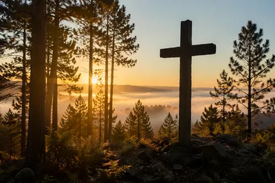 Silhouetted Wooden Cross at Evergreen Sunrise