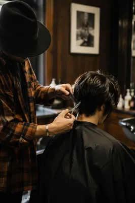 Moody Hairdresser Trimming Client in Salon