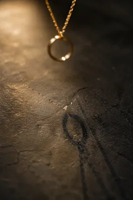 Elegant Gold Pendant Shadow Still Life