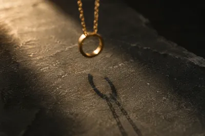 Elegant Gold Pendant Shadow Still Life