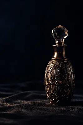 Elegant Gold Perfume Bottle on Dark Velvet