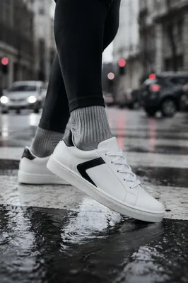White Sneakers on Rainy Urban Crosswalk