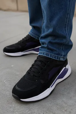 Urban Black Sneakers on Concrete Sidewalk