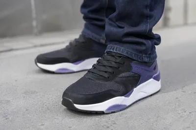 Black Fashion Sneakers on Concrete Sidewalk