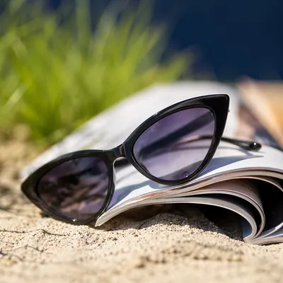 Black Cat-Eye Sunglasses on Summer Sand