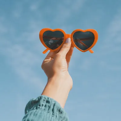 Orange Heart Sunglasses Against Summer Sky