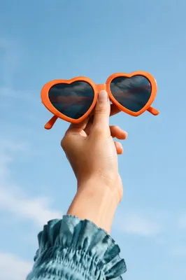 Orange Heart Sunglasses Against Summer Sky