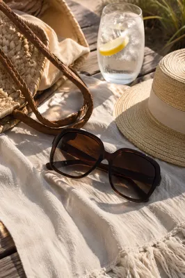 Oversized Sunglasses on Sunlit Beach Towel