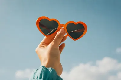 Orange Heart Sunglasses Against Summer Sky
