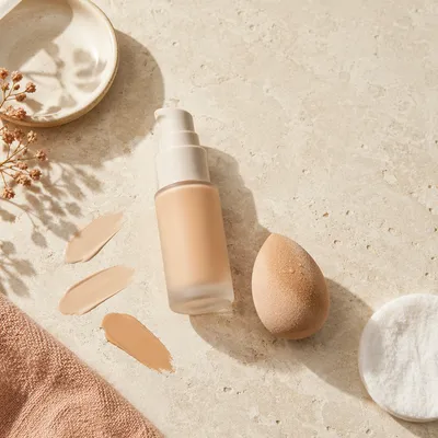 Elegant Foundation Bottle and Beauty Sponge Flat Lay