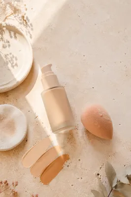 Elegant Foundation Bottle and Beauty Sponge Flat Lay