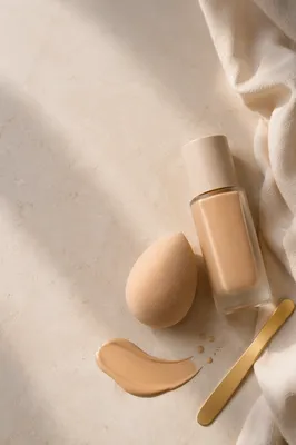 Elegant Beauty Blender and Foundation Flat Lay