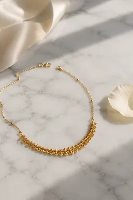 Elegant Gold Necklace on White Marble
