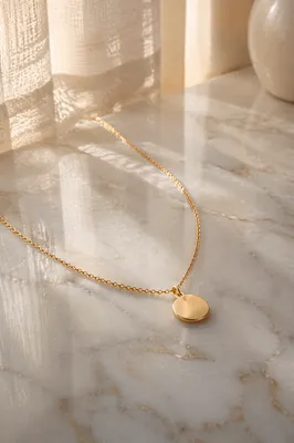 Elegant Gold Necklace on White Marble