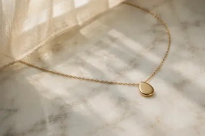 Elegant Gold Necklace on White Marble