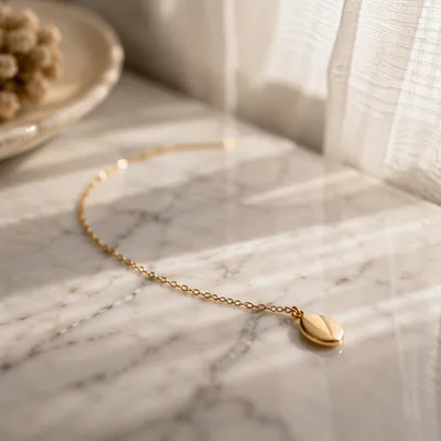 Elegant Gold Necklace on White Marble