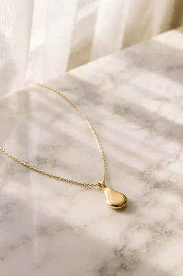 Elegant Gold Necklace on White Marble