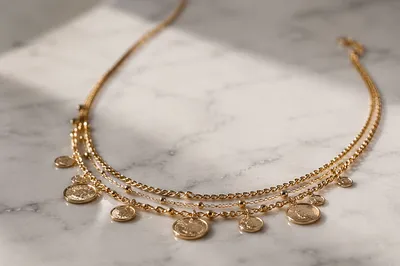 Elegant Gold Necklace on White Marble