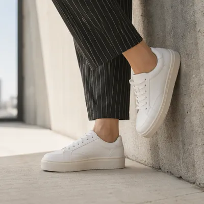 White Platform Sneakers on Concrete Floor