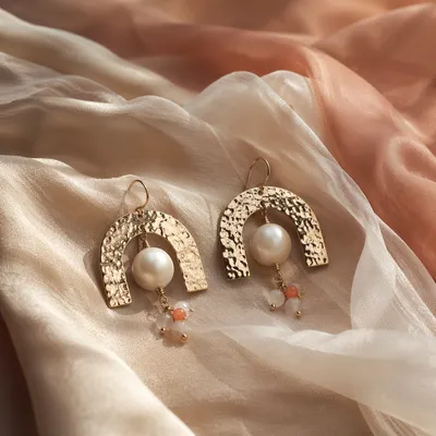 Statement Earrings on Champagne Fabric Close-Up