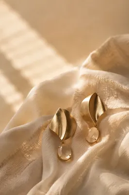 Statement Earrings on Draped Silk Backdrop