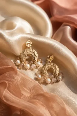 Statement Earrings on Satin Fabric Close-Up