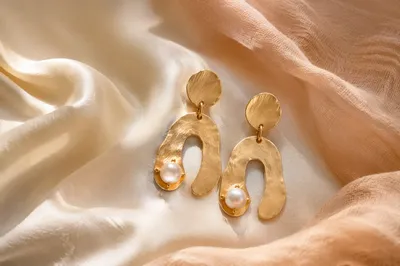 Elegant Statement Earrings on Draped Fabric