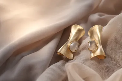 Statement Earrings on Elegant Fabric Backdrop