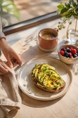 Sunlit Avocado Toast Brunch on Cafe Table