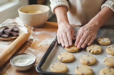 Hands Shaping Cookie Dough in Kitchen