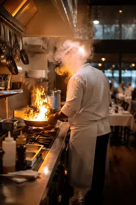 Chef Cooking Over Flame in Restaurant