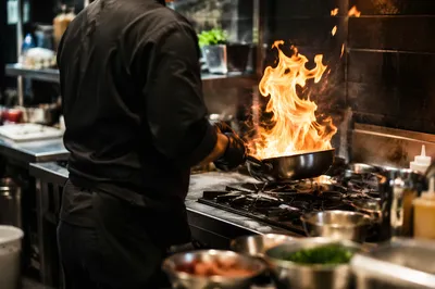 Chef Flambé Action in Restaurant Kitchen
