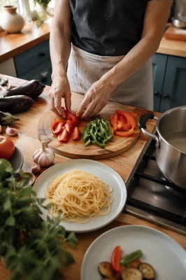 Hands Preparing Vegetable Pasta in Cozy Kitchen