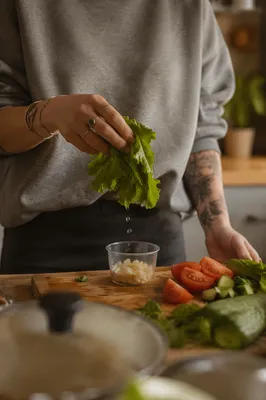 Hands Preparing Fresh Vegetables in Kitchen