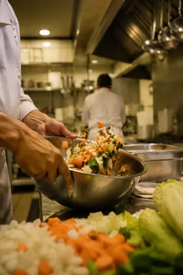 Hands Preparing Vegetables in Commercial Kitchen