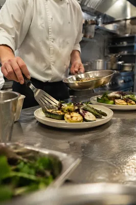 Chef Hands Plating Grilled Vegetables