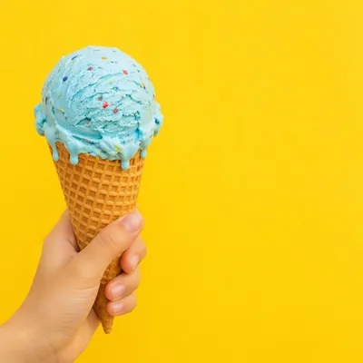 Hand Holding Blue Ice Cream Cone