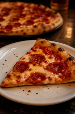 Fresh Pepperoni Pizza Slice on White Plate