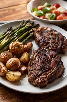 Hearty Grilled Steak Dinner on White Plate