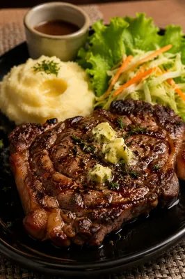 Juicy Grilled Steak Dinner on Black Plate