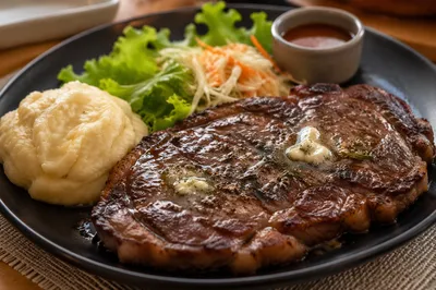 Grilled Ribeye Steak Dinner on Black Plate