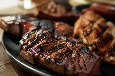 Glazed Grilled Steak on Dark Dinner Plate
