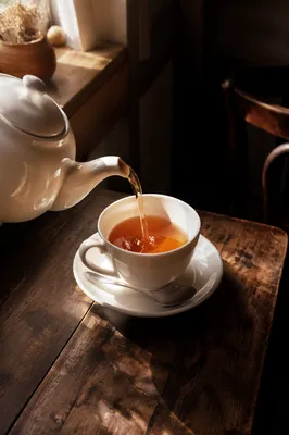 Cozy Ceramic Teapot Pouring Warm Amber Tea