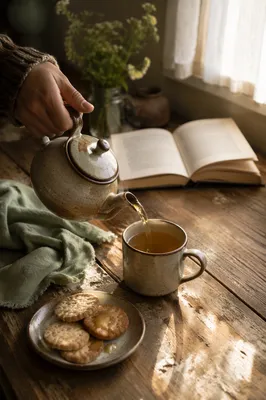 Ceramic Teapot Pouring Tea on Wooden Table