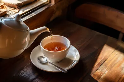 Cozy Ceramic Teapot Pouring Amber Tea