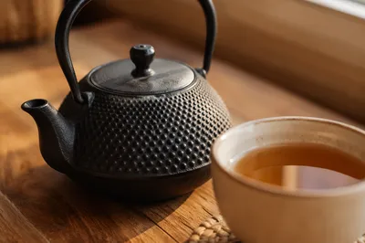 Cozy Ceramic Tea Cup and Black Teapot