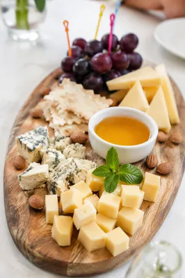 Elegant Cheese Board with Grapes and Honey