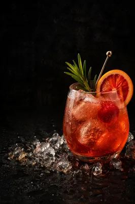 Elegant Herb Garnished Amber Rose Cocktail