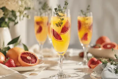 Golden Citrus Cocktail Flutes with Herb Garnish