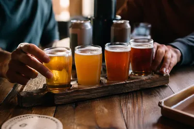 Craft Beer Flight on Rustic Wooden Paddle